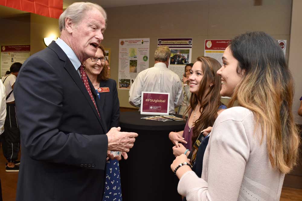 President Thrasher talking to students IEW Opening Reception