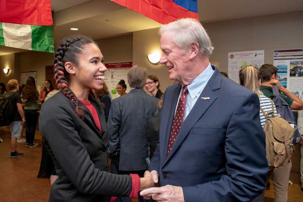 President Thrasher talking to students IEW Opening Reception